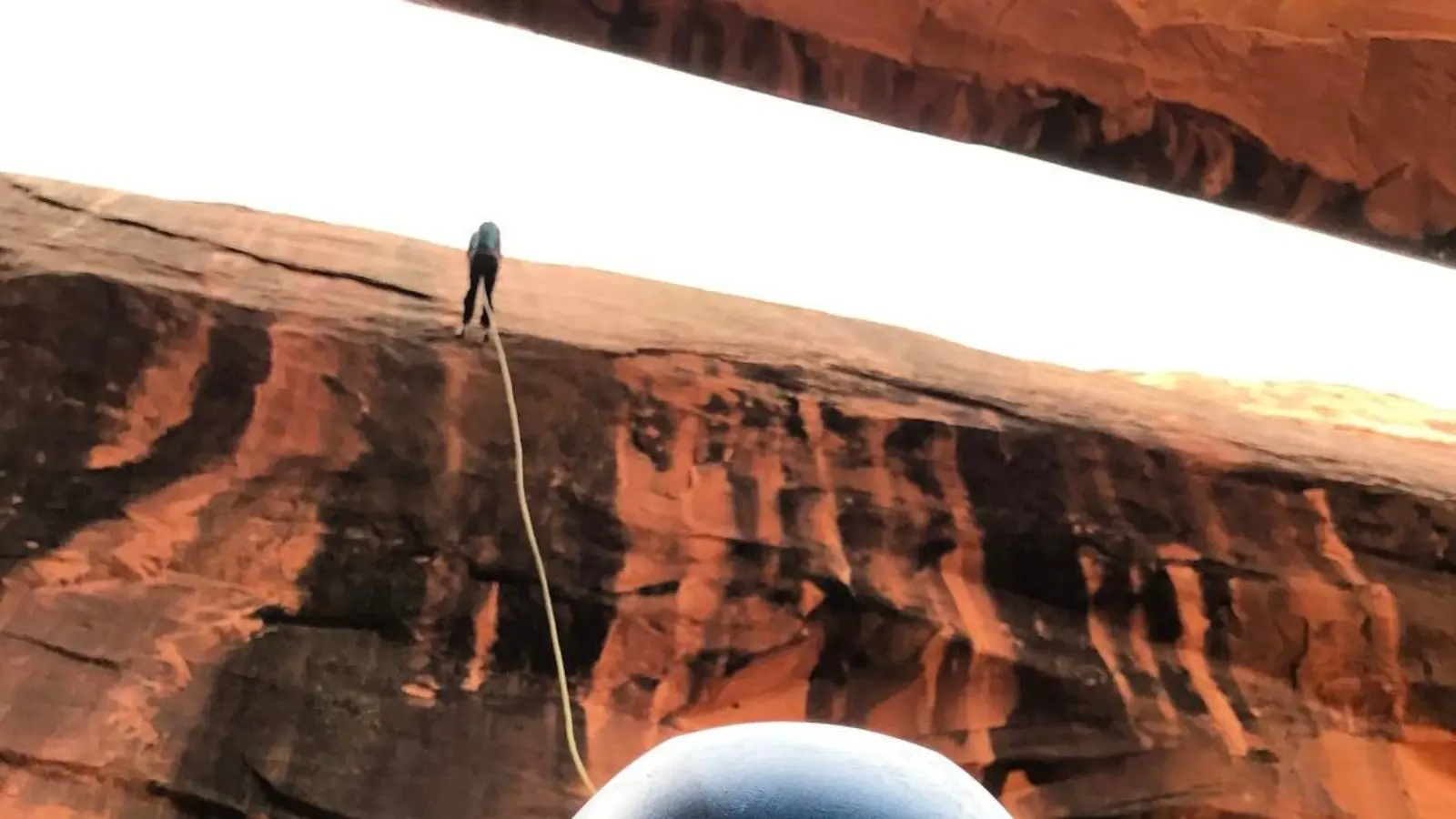 moab tours A person rappels down a large rock formation in Moab