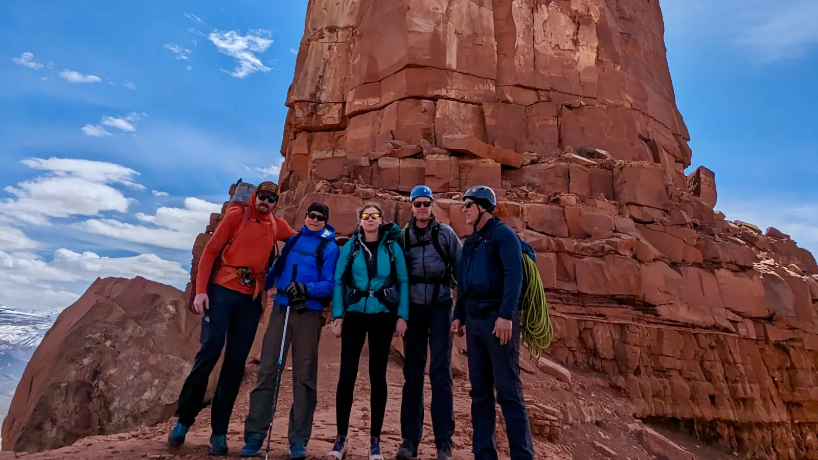 Rock climbing in Moab five people pose in front of a rock feature in moab